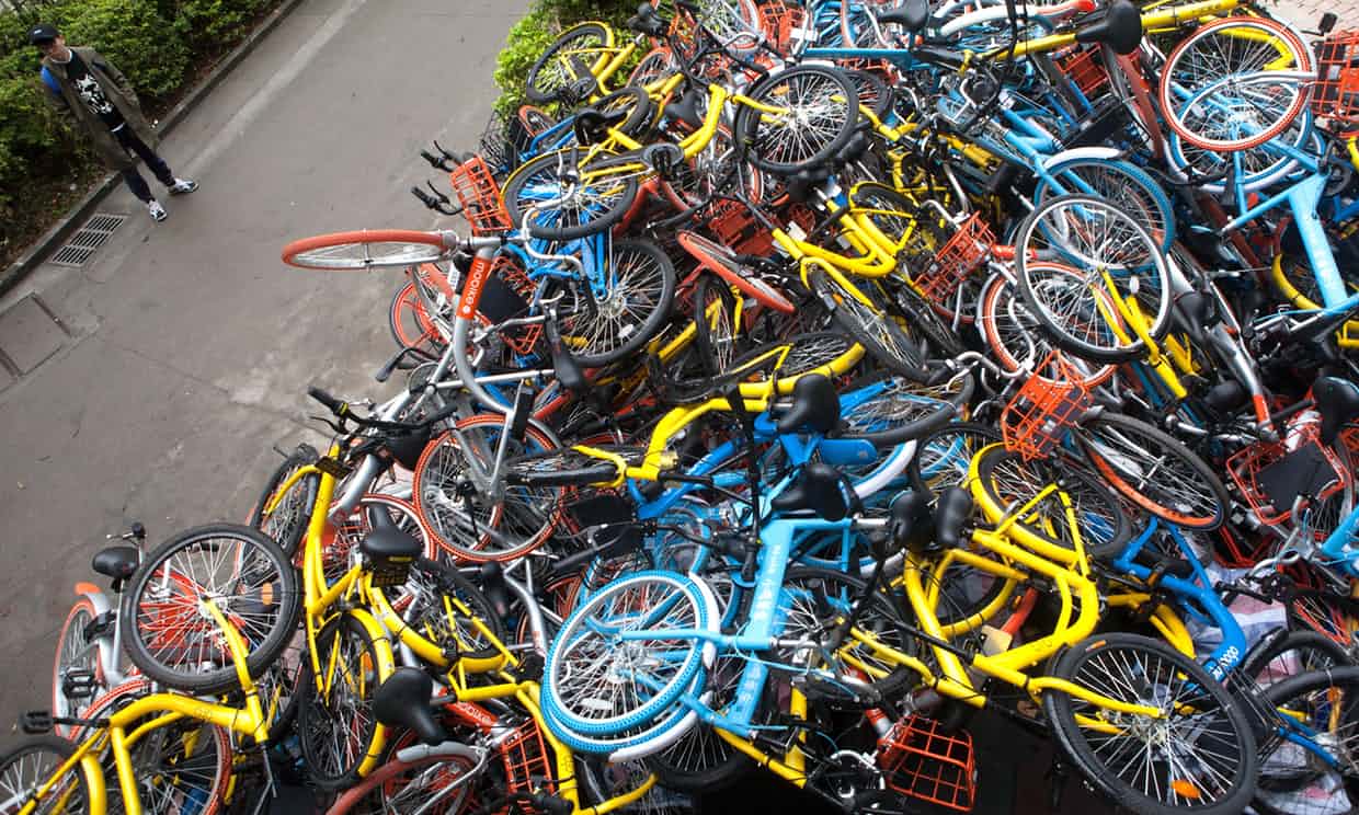 Share bikes dumped in huge piles near the entrance of Xiashan park in Shenzhen. Photograph: Imaginechina/Rex/Shutterstock