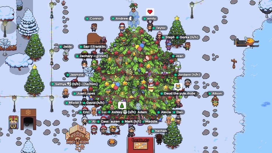 A winter Space in Gather with a giant decorated Christmas tree and about 30 avatars standing around the tree.