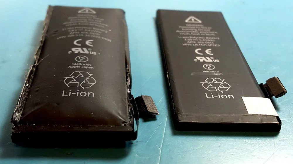 two phone batteries side by side, one is bulging