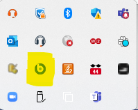 Windows system tray expanded showing a grid of icons. The BigFix icon is highlighted in yellow.