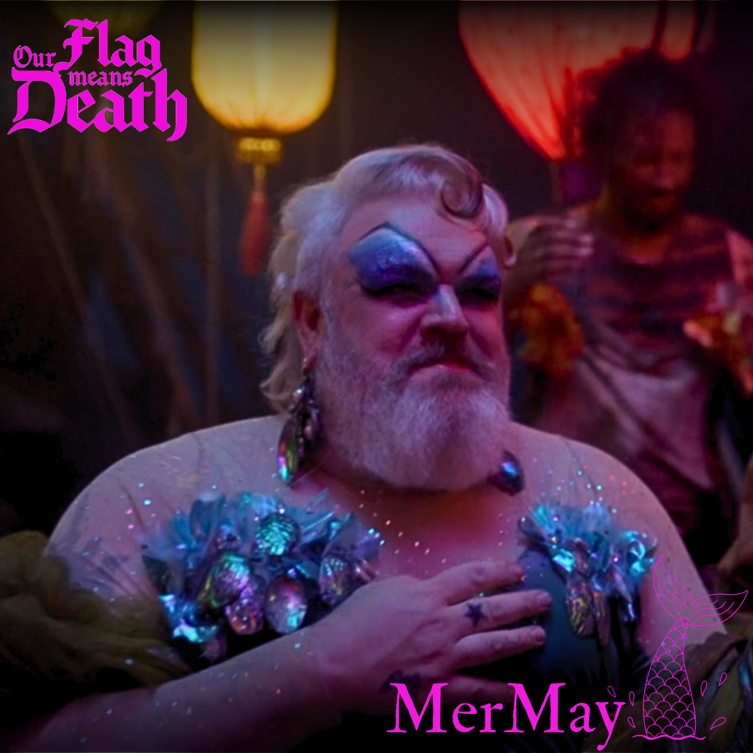 A still from the show, overlaid with the SaveOFMD Crew MerMay 2024 sticker. The still shows Wee John in drag as Calypso. 