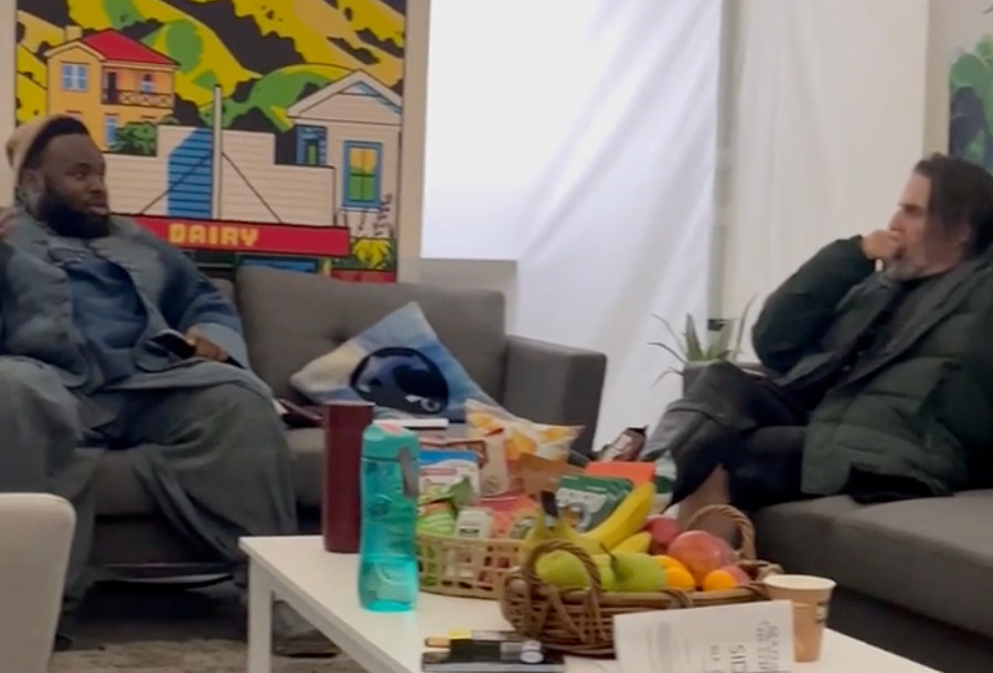 screenshot of a video of Sampson Kayo and Con' O'Neill chatting on couches.