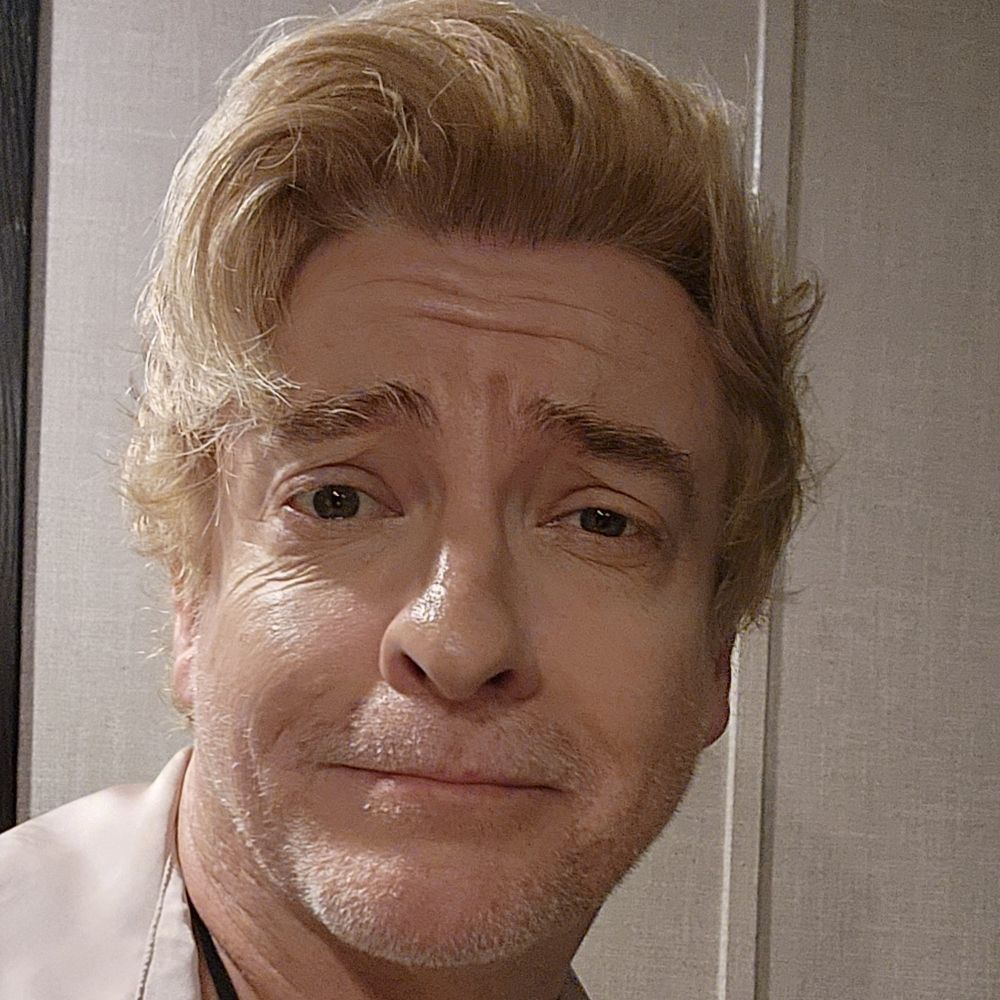 Picture of Rhys Darby looking endearing and gorgeous as usual with his blonde hair and adorable wrinkles