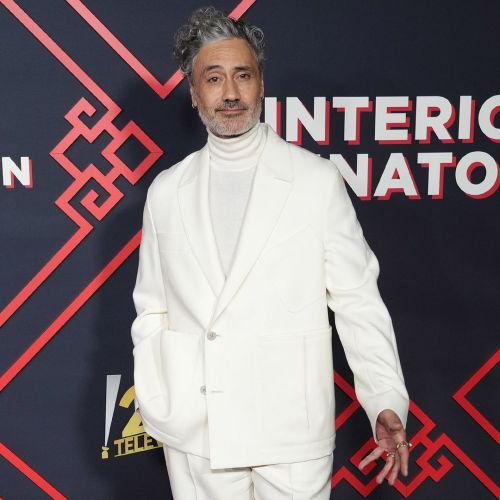 taika waititi in a white suit, and hair lost containment