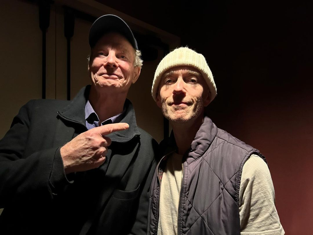 Two older gentleman smiling for the camera, the one on the right is Adam Stein