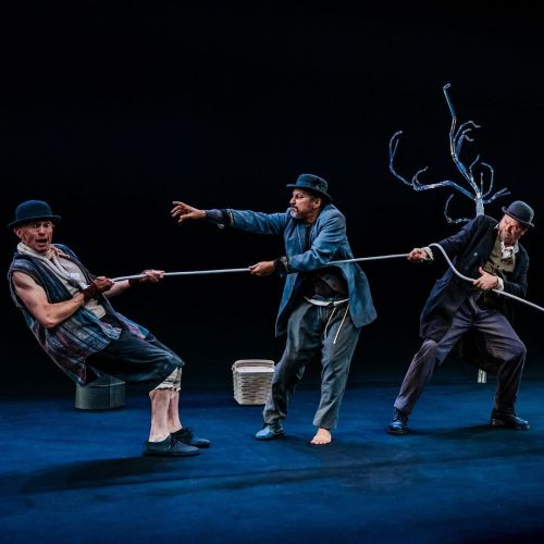 Adam stein in a bowler had in Waiting for Godot hanging by a rope that two other people are pulling