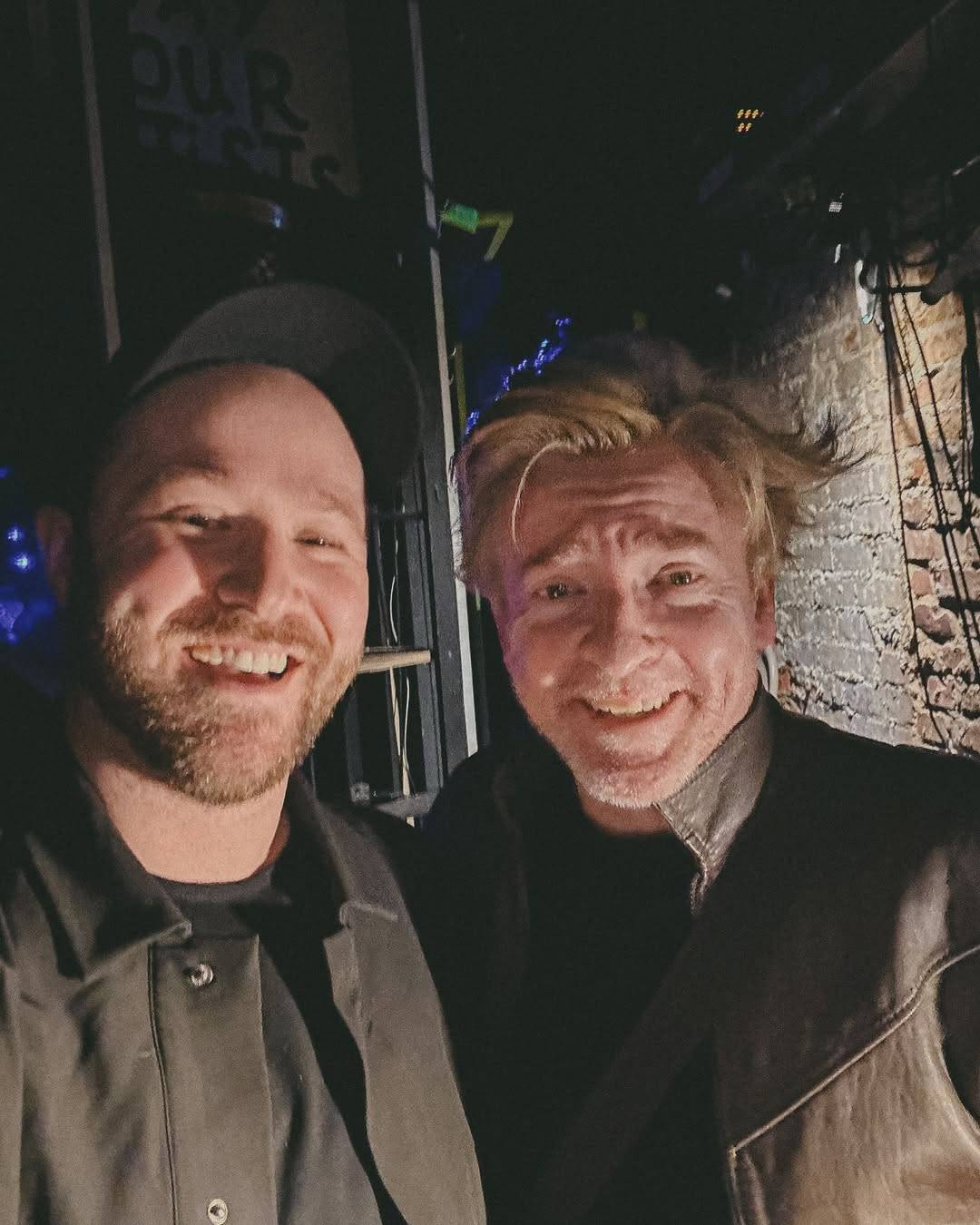 Selfie of Rhys and event photographer Tyler Middendorf at the Bourbon Room, both of them smiling broadly at the camera.