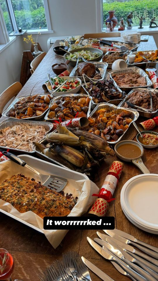 A large dining table absolutely laden with food. There are several different kinds of meat, roasted vegetables, salads, homemade sauces and more. Text at the bottom reads: 'It worrrrrked ...'