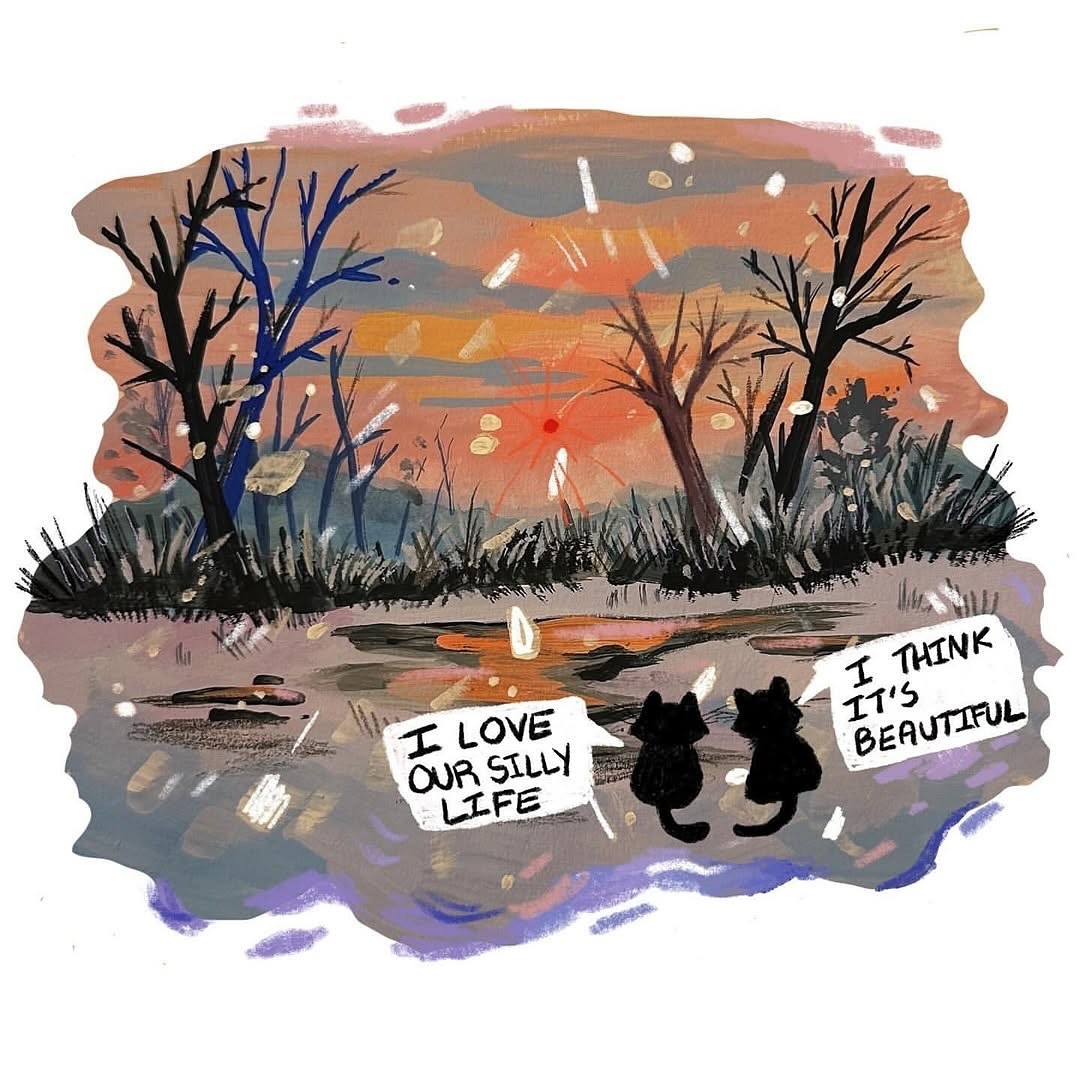 Another illustration: Two black cats, seen from behind, sit and watch a winter sunset as snow falls around them. The ground beneath them is grey and the trees in front of them are bare, but the sky is a beautiful mix of blue, yellow, orange and pink, the sun shining red. The two cats have speechbubbles, with one saying 'I love our silly life' and the other responding 'I think it's beautiful'.