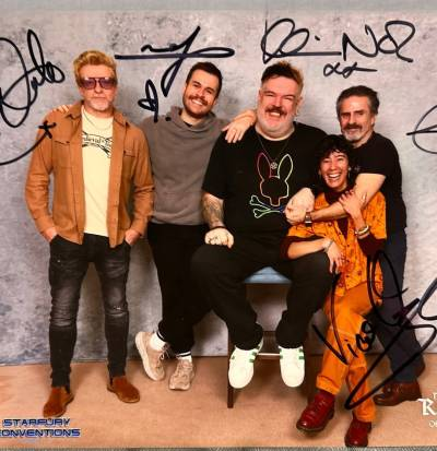 A photo of Rhys, Nathan, Kristian, Con and Vico, taken at StarFury Convention. They have each signed their name on the photo.