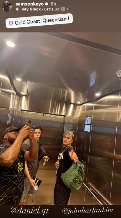 Samson Kayo's Instagram story with a picture of him and two other men in an elevator. Samson is holding his phone up above his head to take a photo of their reflection in the mirrored back wall of the elevator. Above the photo, there is a location tag reading 'Gold Coast, Queensland', and below, Samson has tagged @ daniel.qt and @ JohnHarlanKim. 