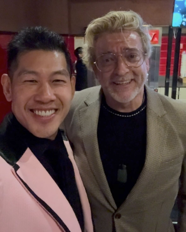 Selfie of Rhys and another man, possibly a friend or fellow cast member, at the Love Hurts premiere. Both are looking at a camera with big, open-mouthed smiles.