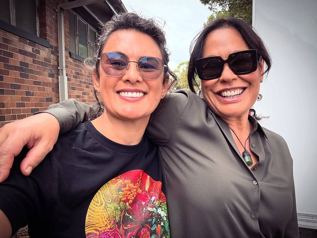 Selfie of Rachel House and fellow actor Kylie Bracknell. They are both wearing sunglasses and looking at the camera with big, open-mouthed smiles, and one of Rachel's arms is draped around Kylie's shoulders.