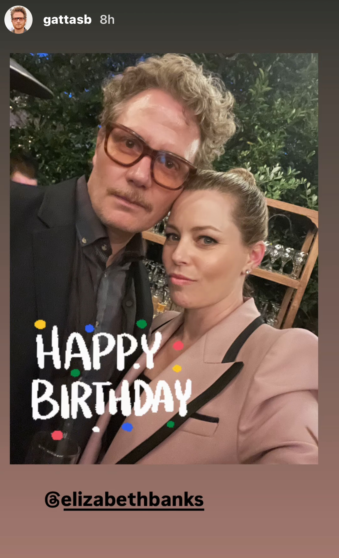 Instagram Story from Brian Gattas (@ GattasB), featuring a selfie of himself and Elizabeth Banks, on which he has placed an Instagram sticker that reads 'Happy Birthday' in white capital letters surrounded by confetti. He has also tagged her Instagram account, ElizabethBanks.