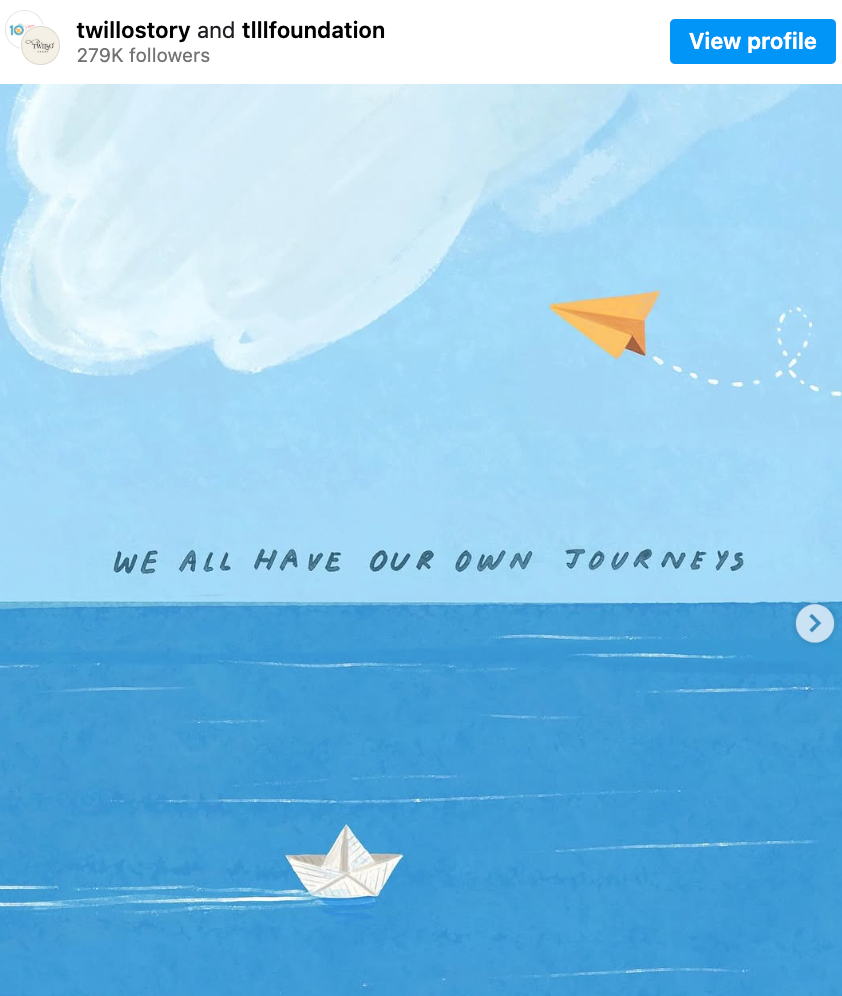 Instagram post from TwilloStory and TLLLFoundation: painting showing a paper plane flying over a calm ocean, where a paper boat floats in the opposite direction. The words 'We all have our own journeys' are written on the horizon line between the plane and the boat. The painting is signed '@ TwilloStory'.