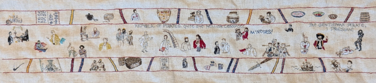 Image description by the artist: Small embroidery in the style of the Bayeux Tapestry. The central panel depicts episode 3 of the TV show Our Flag Means Death with smaller panels above and below featuring additional scenes and items from the episode.