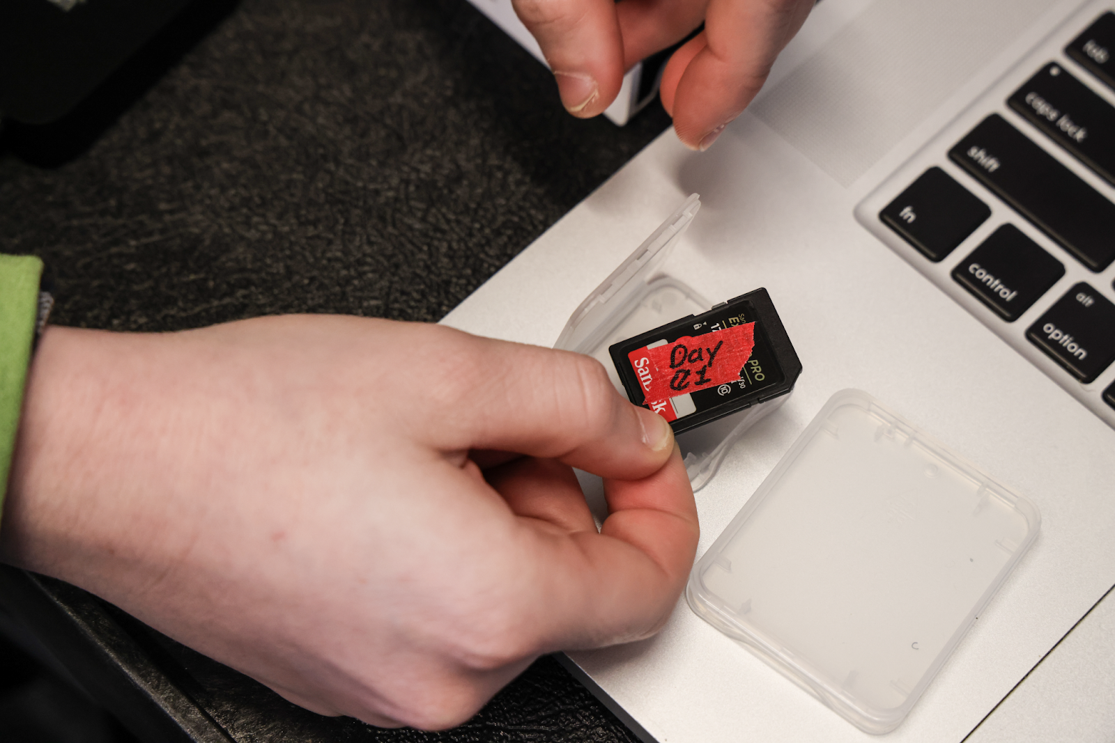 SD card with red tape labeled Day 01 in a case.