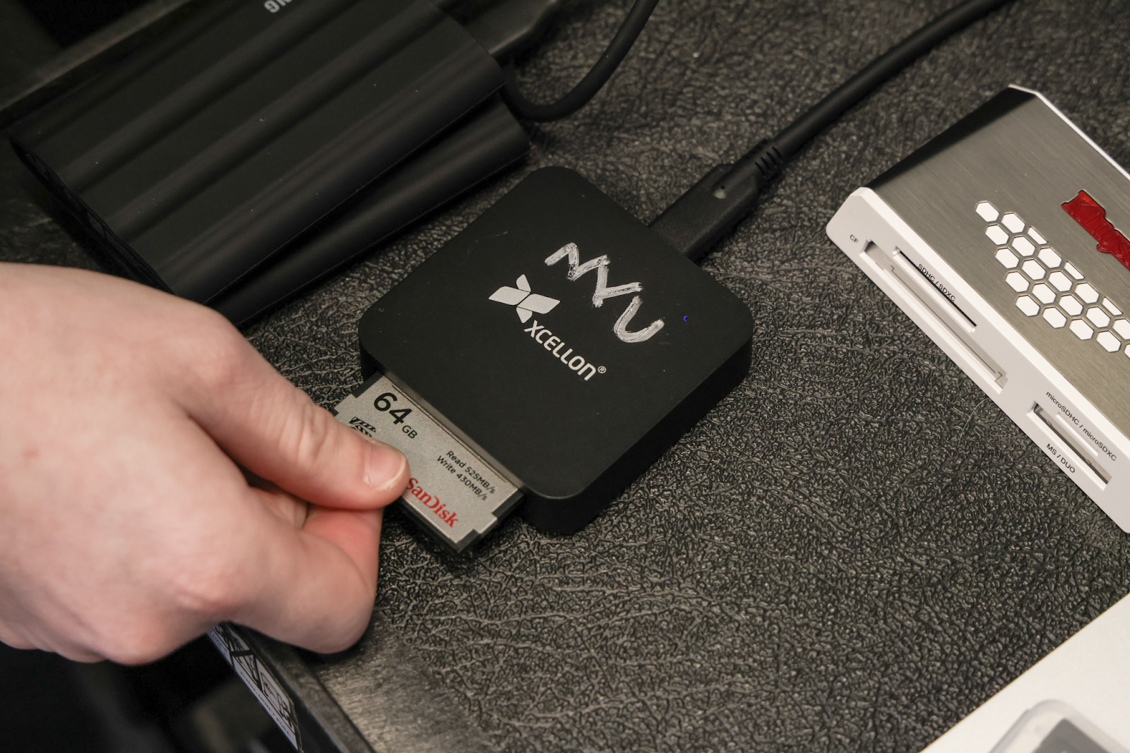 Inserting the CFast2.0 card into the Xcellon single card reader.